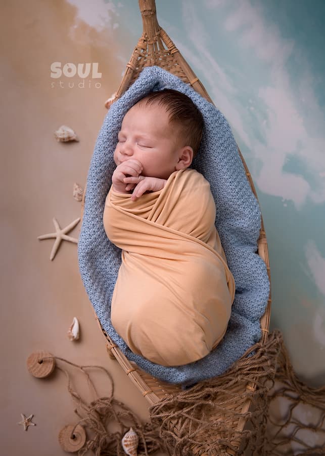 fishing sea floating boat baby boy sitter non-sitter beach starfish seashells blue sky ocean sailor